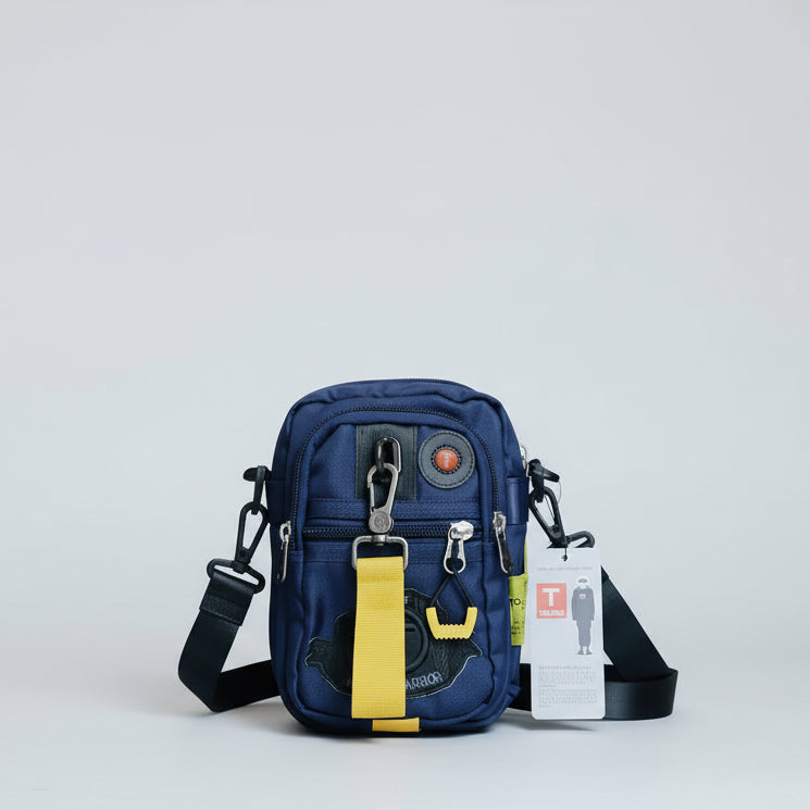 Blue tactical pouch with yellow accents on a wooden surface
