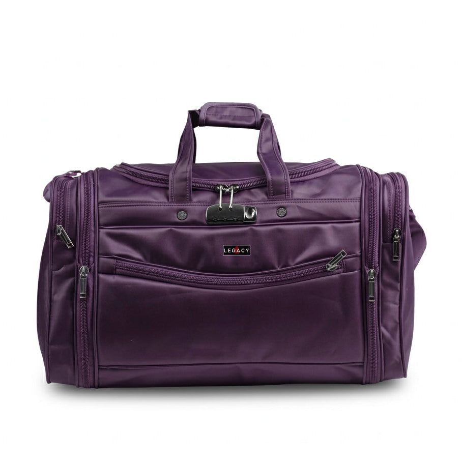 A purple Legacy brand duffel bag with multiple zippered pockets and top handles, shown on a white background with a Legacy logo at the top and an orange-red banner at the bottom containing the website.
