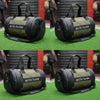 Two green duffel bags with black handles and 'arctic hunter' branding on a grassy background.