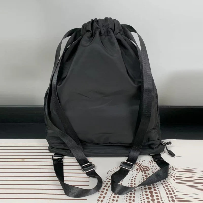 Black drawstring backpack on a textured surface with a neutral background

Backpack, Gym Bag, Drawstring Bag, Sports Gear

Stay organized during workouts, football practice and everyday activities with this versatile sports drawstring backpack. Designed with a spacious main compartment, convenient side mesh pockets and a separate lower compartment for shoes, it helps keep your sports essentials organized.