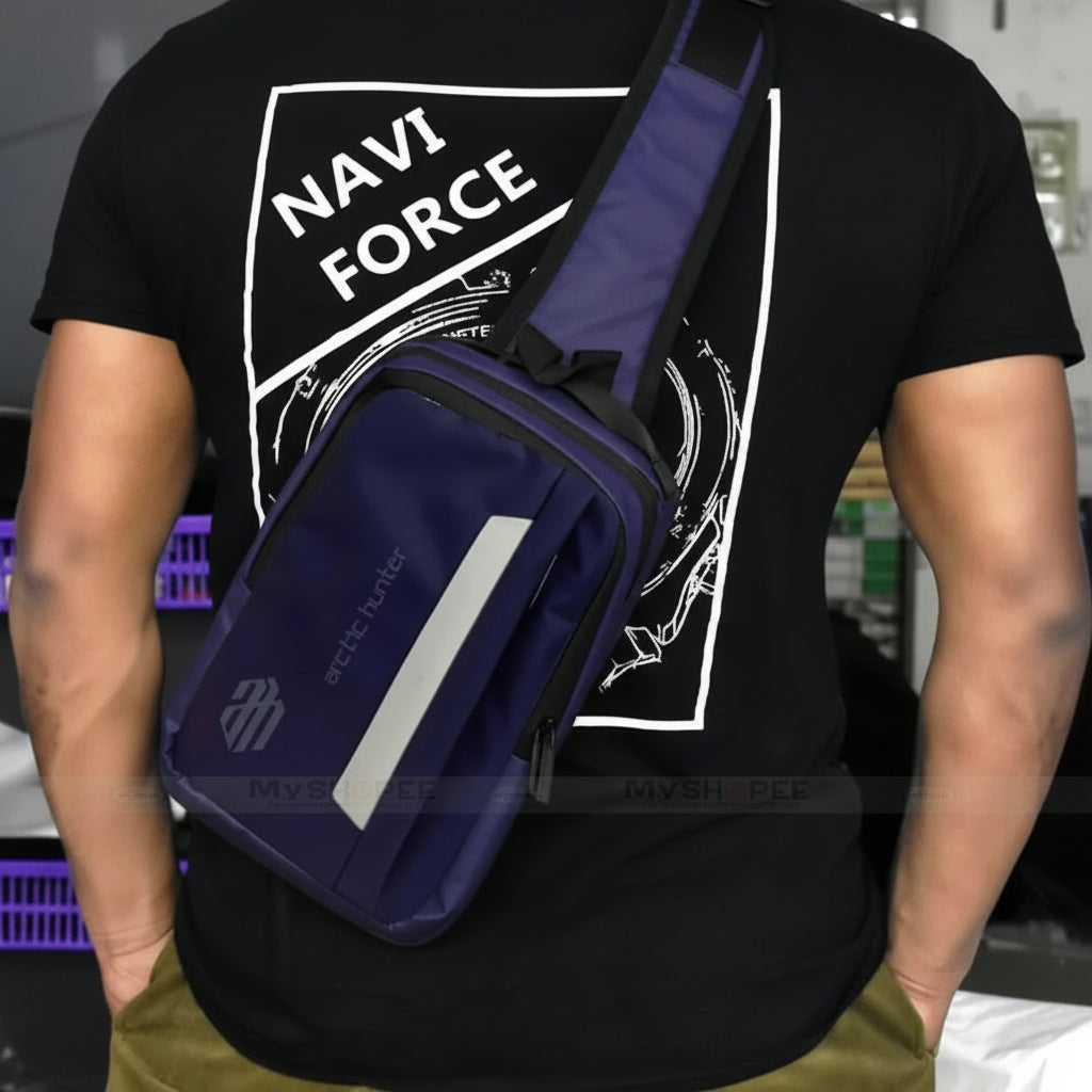 Person wearing a black t-shirt with 'NAVI FORCE' text and a navy blue bag.