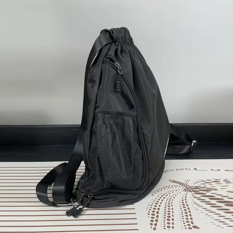 Black drawstring backpack on a white surface with a neutral background

Product Type: Backpack, Gym Bag, Drawstring Bag, Sports Gear

Features: Shoe Compartment, Side Mesh Pocket, Waterproof, Lightweight, Adjustable Straps

Color Variations: Black Gym Bag, Grey Gym Bag

Audience: Unisex, Men's Bags, Women's Bags, College Students, Athletes

#GymBag #DrawstringBackpack #SportsBag #FitnessGear #GymLifestyle #TravelBag #ShoeCompartmentBag #WaterproofBag #SportsBackpack #DailyBackpack